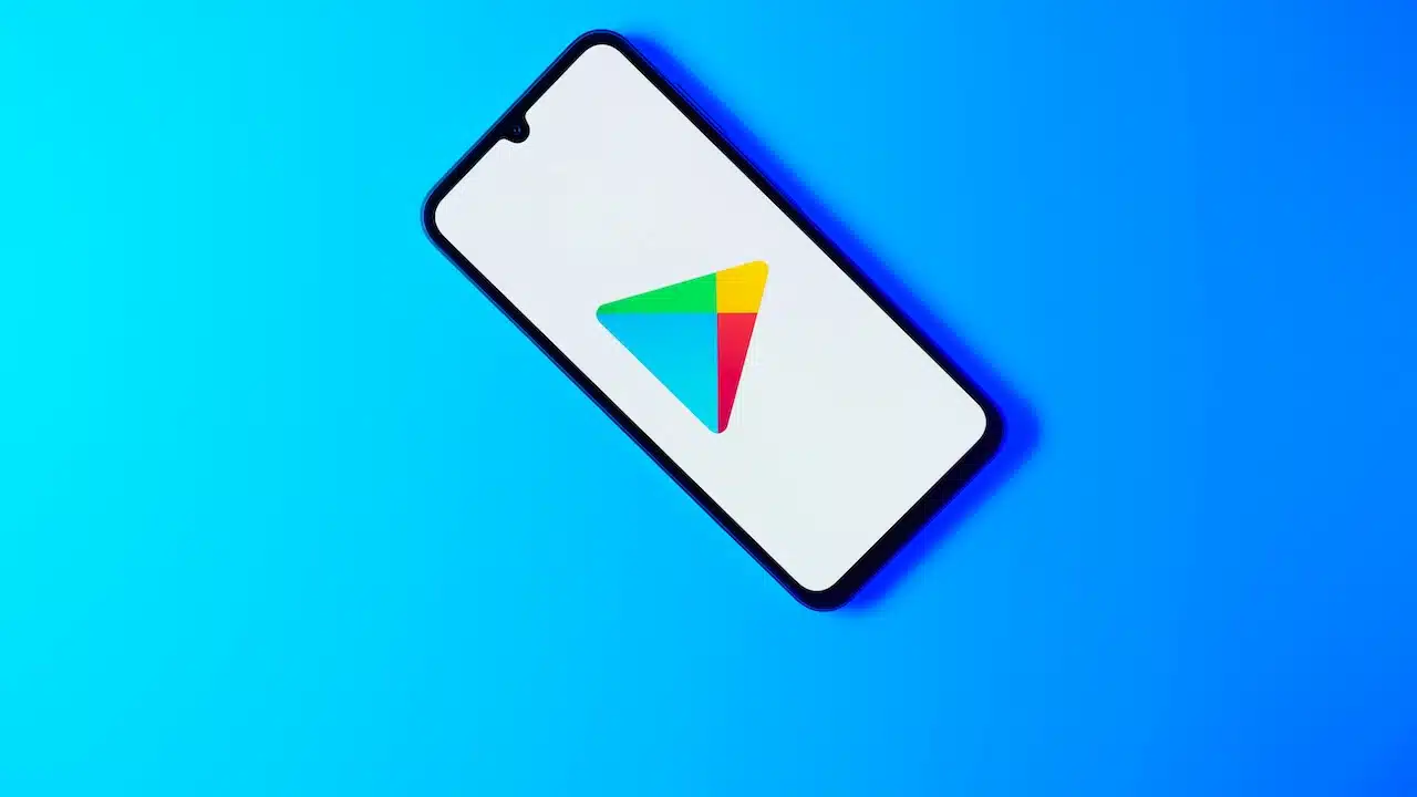 Smartphone on surface showing Google Play logo. Google Play is an app store.