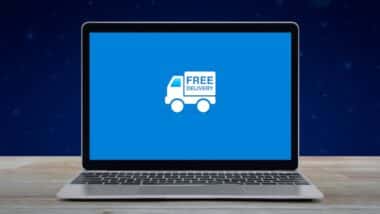Free delivery truck flat icon on modern laptop computer screen