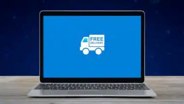 Free delivery truck flat icon on modern laptop computer screen