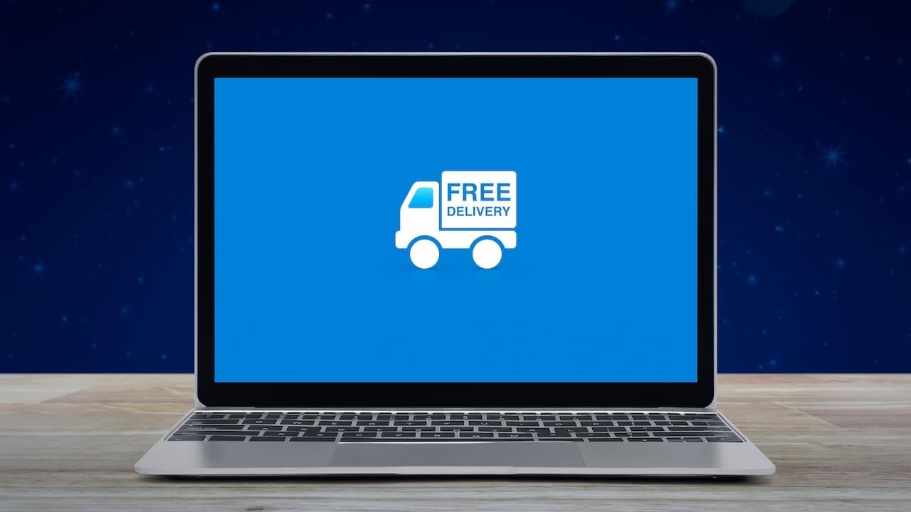 Free delivery truck flat icon on modern laptop computer screen