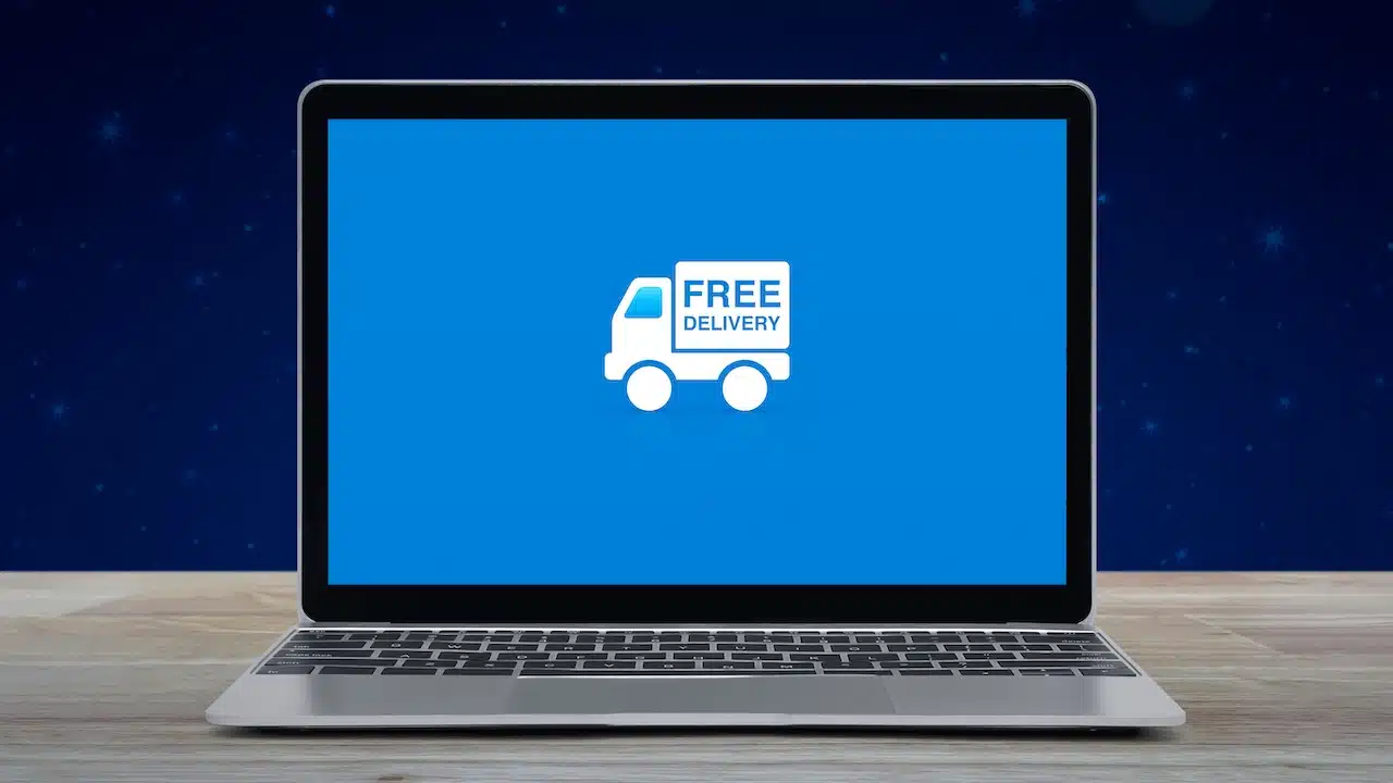 Free delivery truck flat icon on modern laptop computer screen