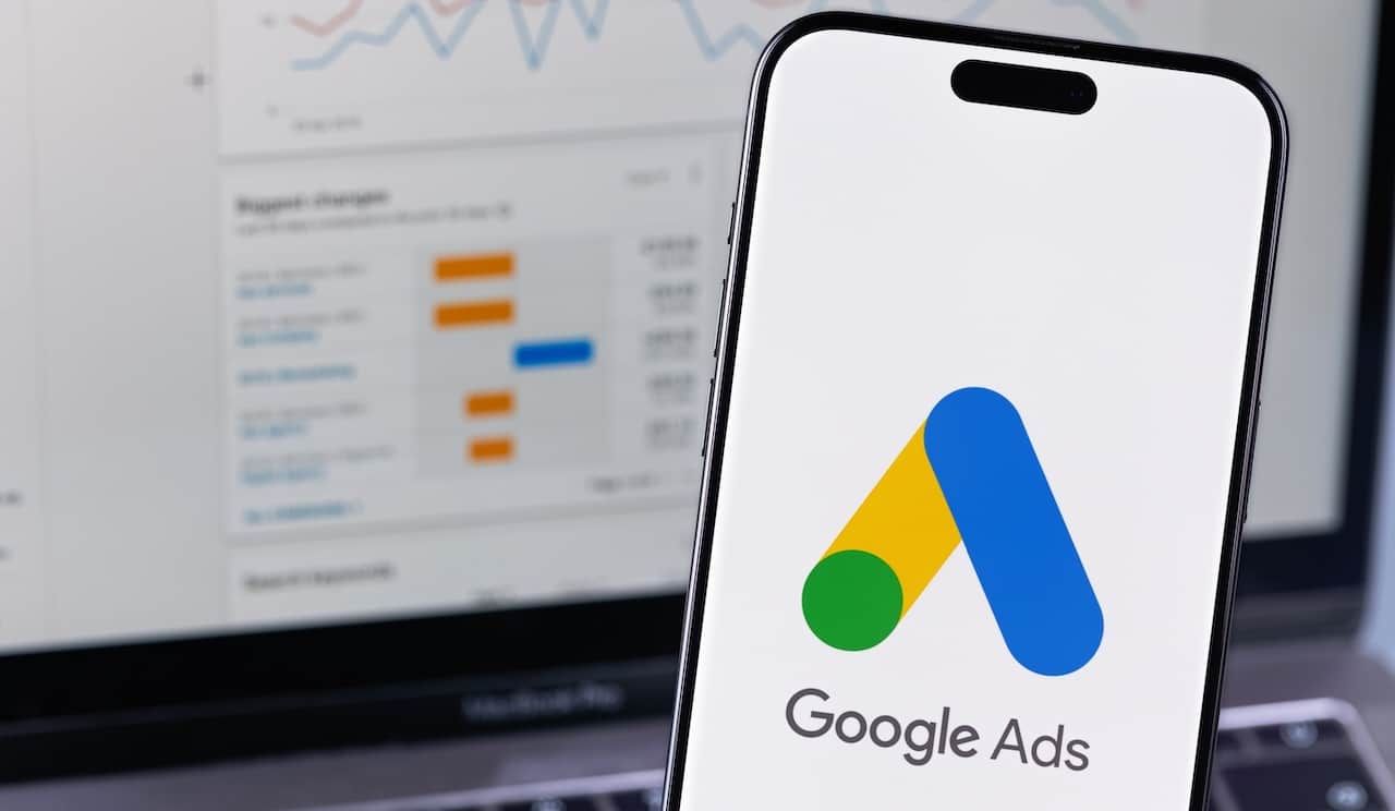 Google Ads logo app on a screen smartphone iPhone and notebook. Ads is a service of contextual, basically, search advertising from Google.