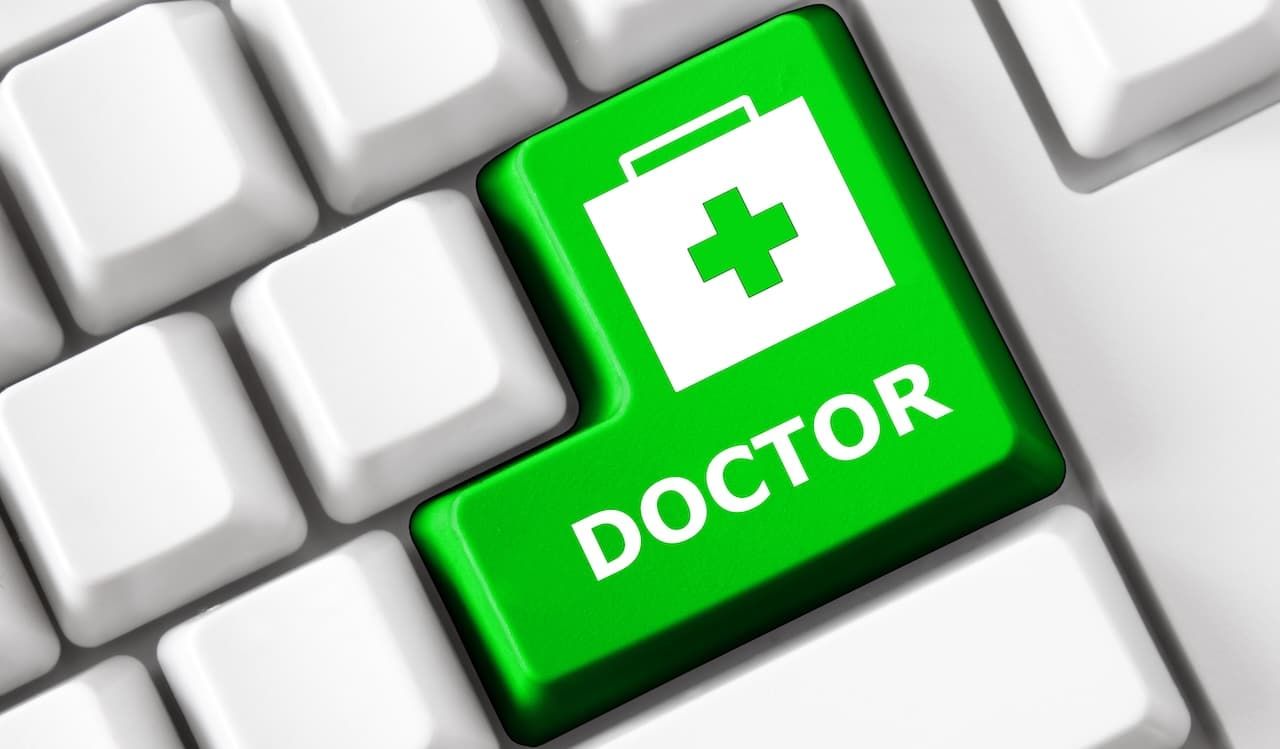 Color button on the keyboard with doctor suitcase image and doctor text. Online Health care concept.
