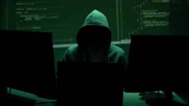 Anonymous hacker represents cyberattack risk and data breach concept.
