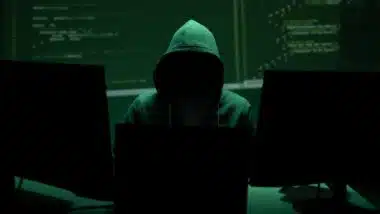 Anonymous hacker represents cyberattack risk and data breach concept.