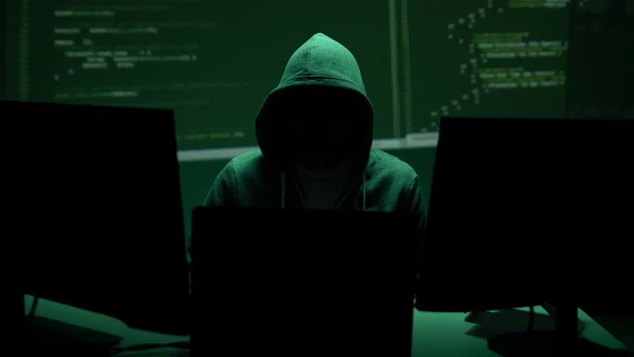 Anonymous hacker represents cyberattack risk and data breach concept.