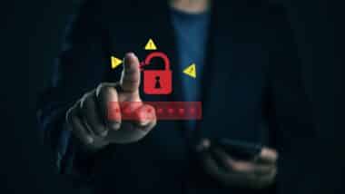 Red open padlock icon and warning signs, concept of cybersecurity breach.