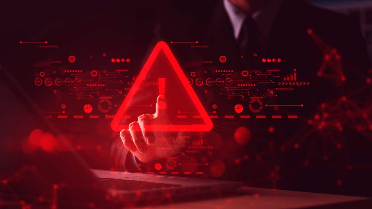 System hacked warning alert on notebook.