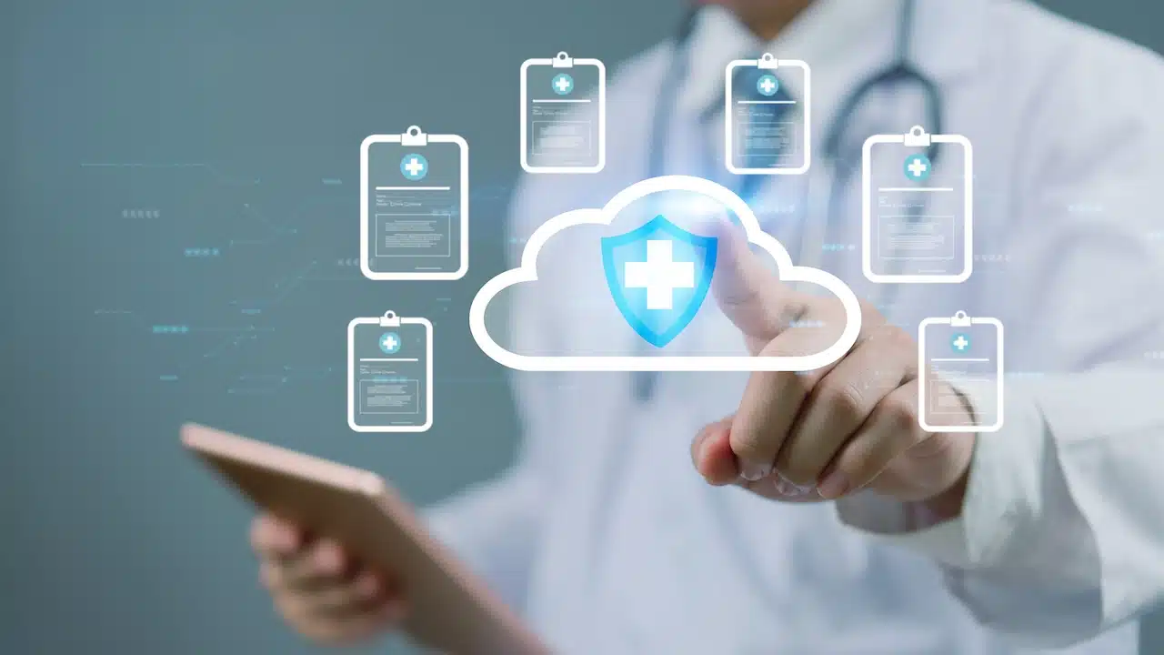 Doctor using digital tablet to access medical records on cloud storage.