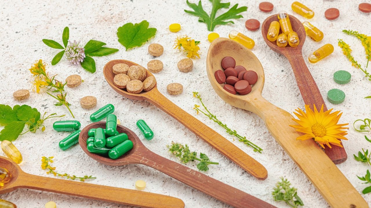 supplements, natural vitamins with fresh herbs and flowers.