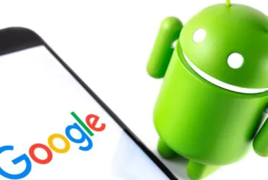 Google Android figure and smartphone with Google logo.