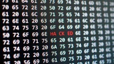 Dramatic digital security breach concept, 'hacked' alert on computer screen