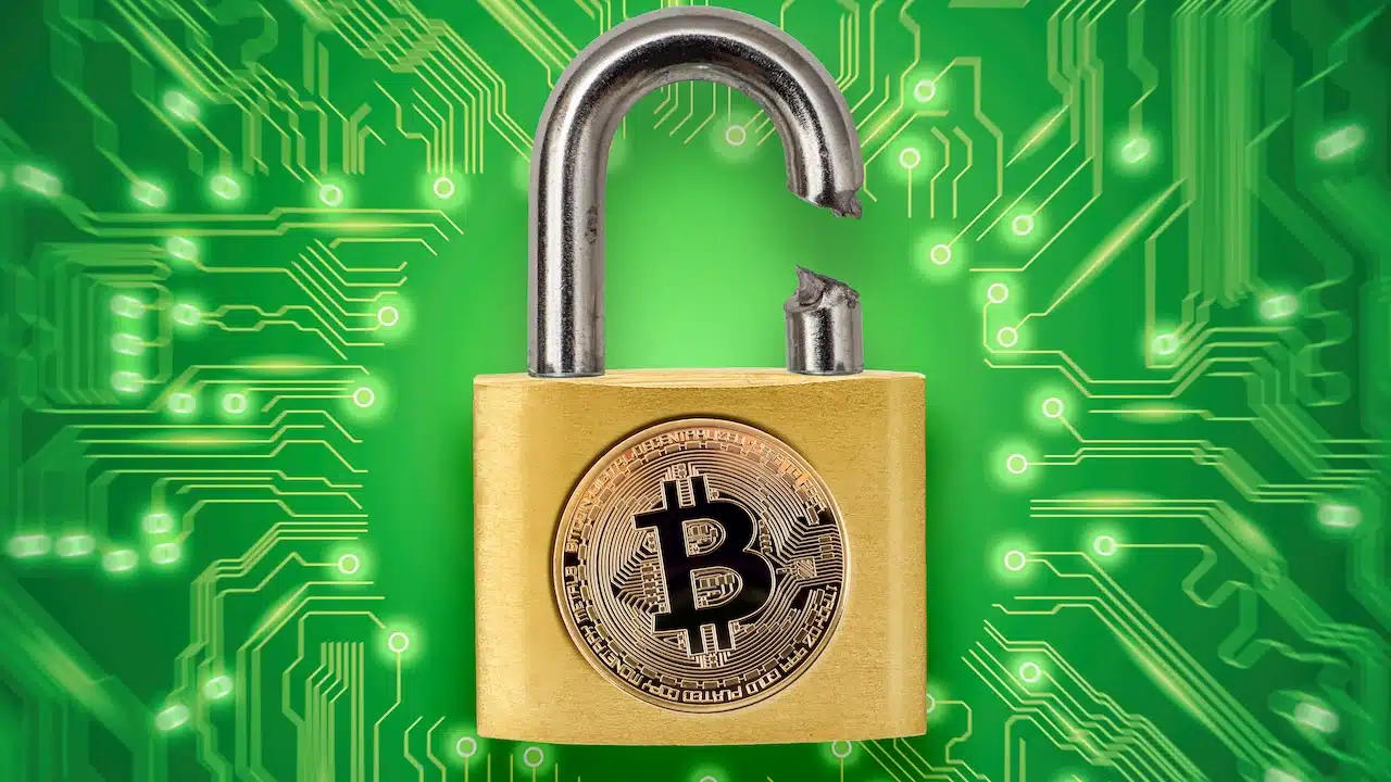 Broken padlock with bitcoin logo.