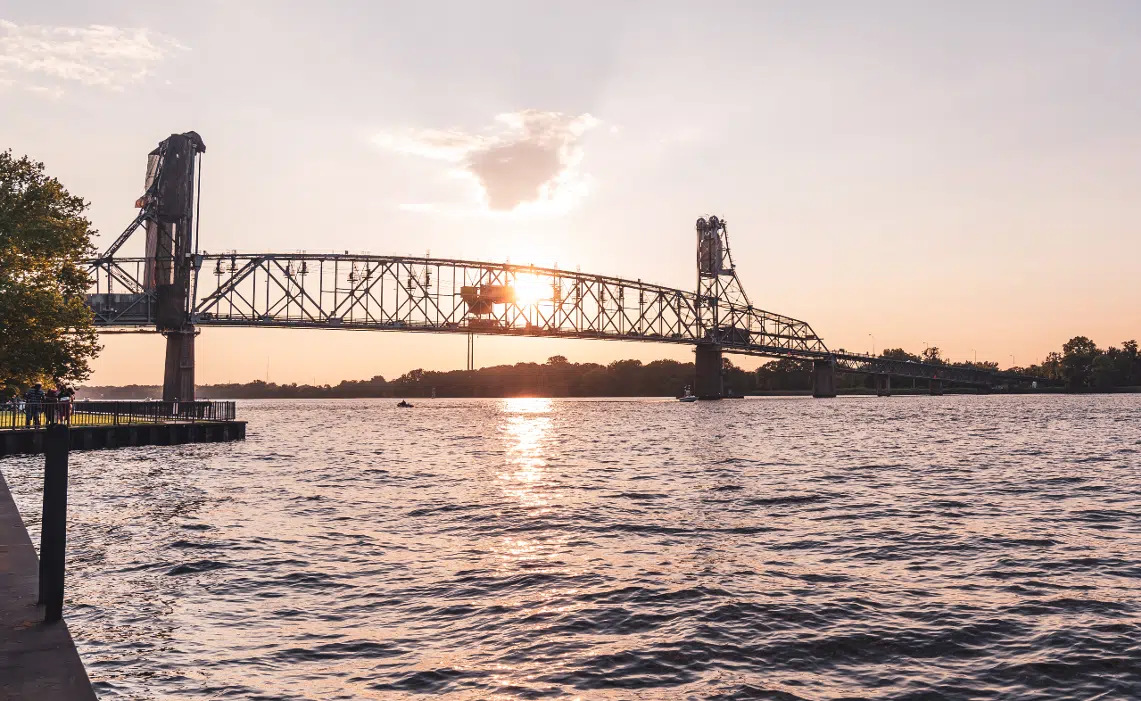 Burlington Bristol Bridge vertical lift bridge in New Jersey and Pennsylvania at sunset with purple golden sky.