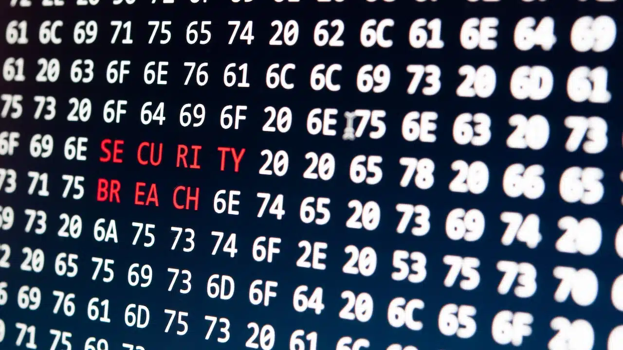 Digital data breach concept displaying "security breach" in glowing alphanumeric code.