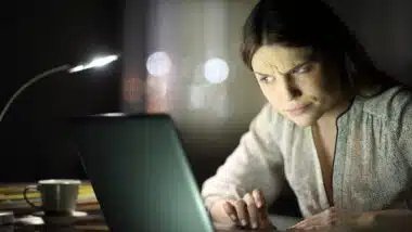 woman checking laptop content late hours