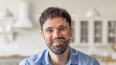 Facial recognition technology highlights his features with geometric overlays, emphasizing identification capabilities.