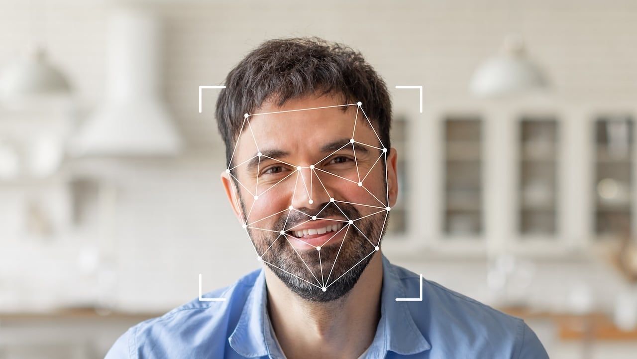 Facial recognition technology highlights his features with geometric overlays, emphasizing identification capabilities.
