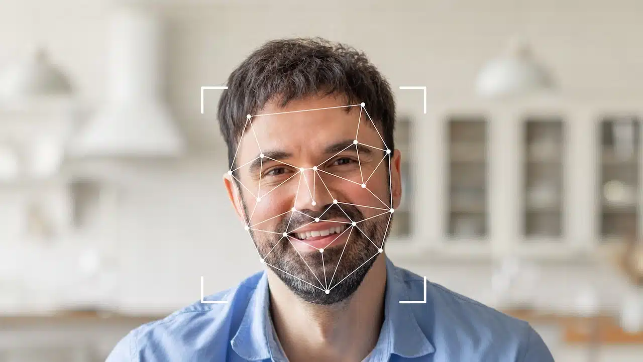 Facial recognition technology highlights his features with geometric overlays, emphasizing identification capabilities.