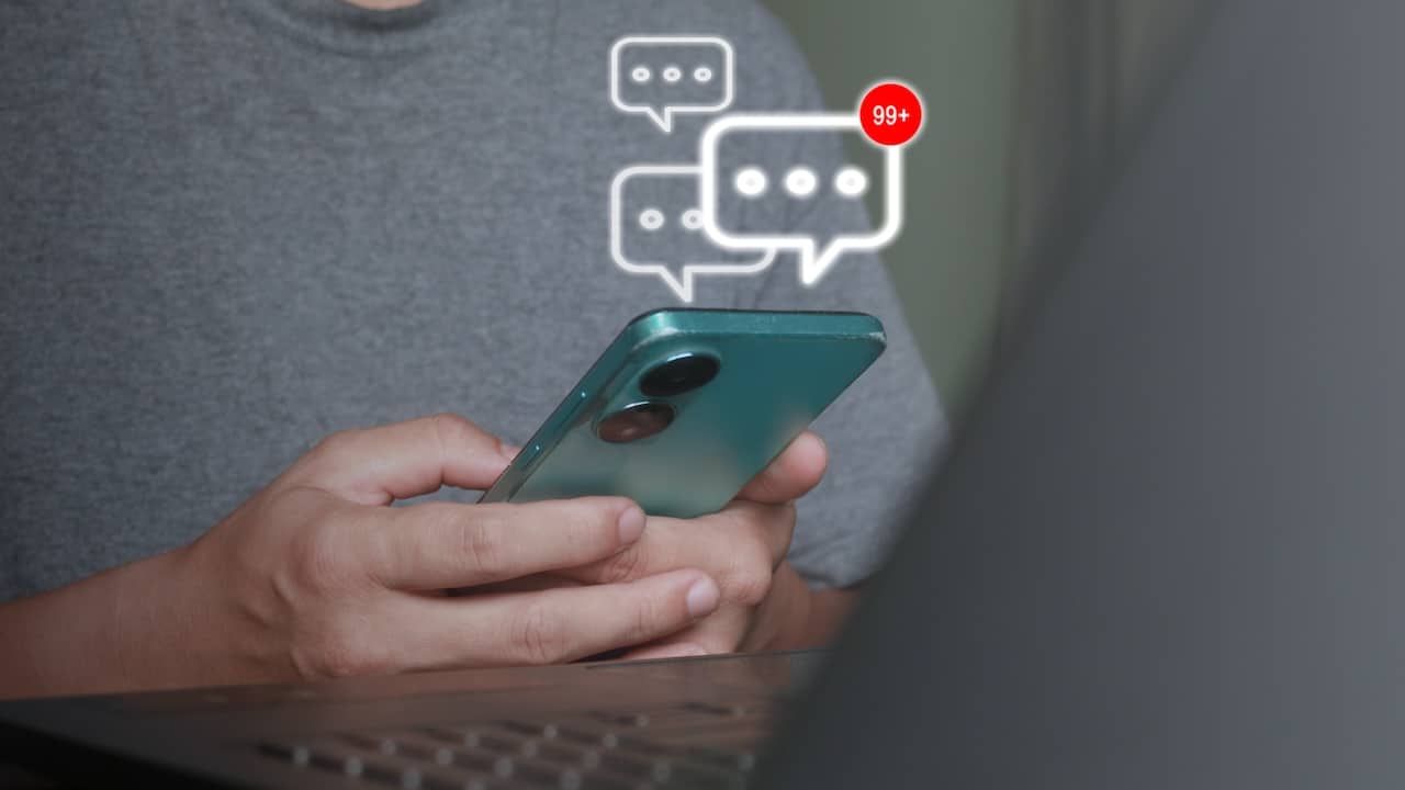 Mobile chat notification with 99+ unread messages on smartphone.