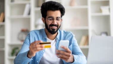 Man using Smartphone And Credit Card