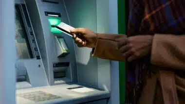woman withdrawing money from ATM machine