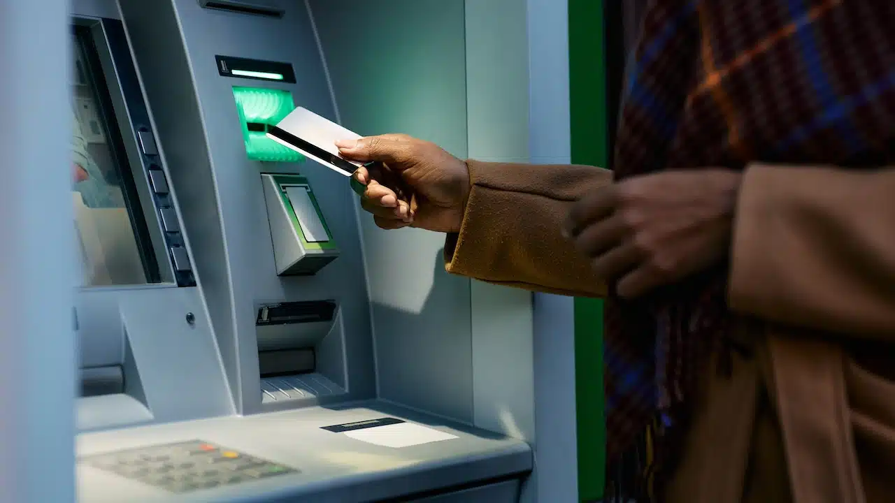 woman withdrawing money from ATM machine