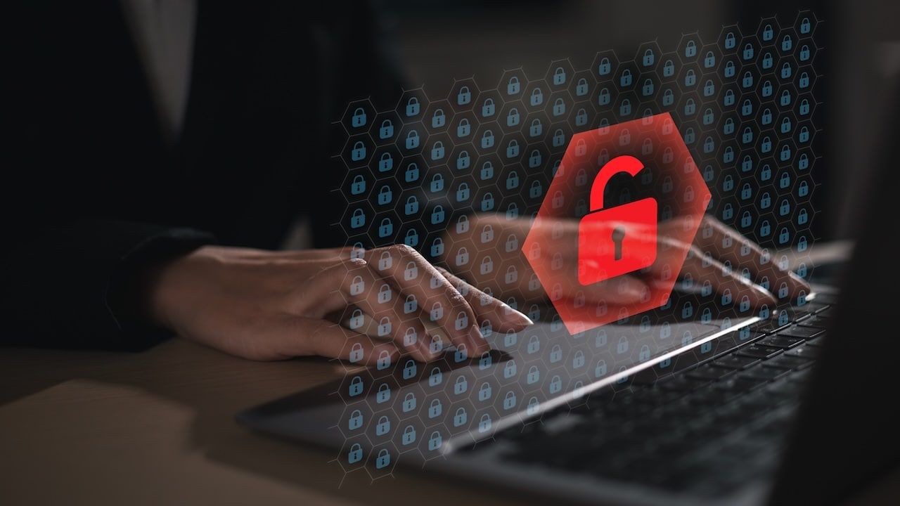 Cyber ​​security risk and data breach concept. Businessman using laptop with digital key icon.
