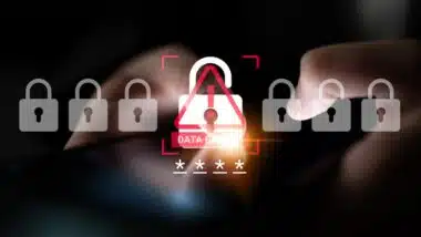 Close-up of a smartphone displaying a data breach alert