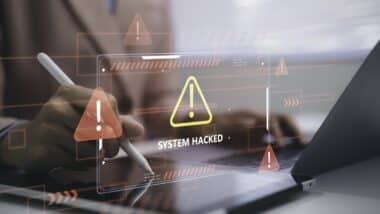 Business person using tablet with system hacked warning cybersecurity alert data breach protection risk network security threat detection digital technology and information safety