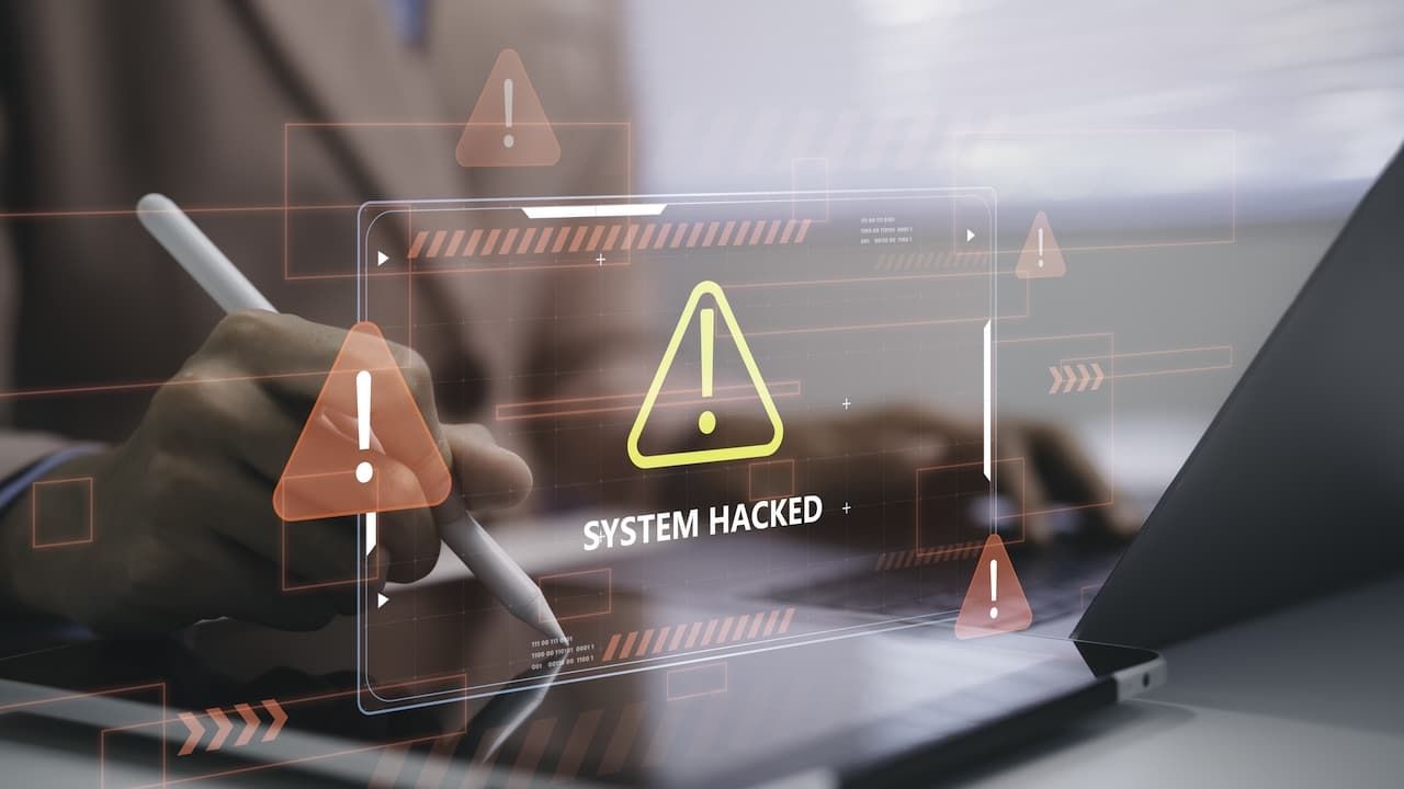 Business person using tablet with system hacked warning cybersecurity alert data breach protection risk network security threat detection digital technology and information safety