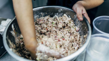 Kitchen staff making large quantity of tuna salad