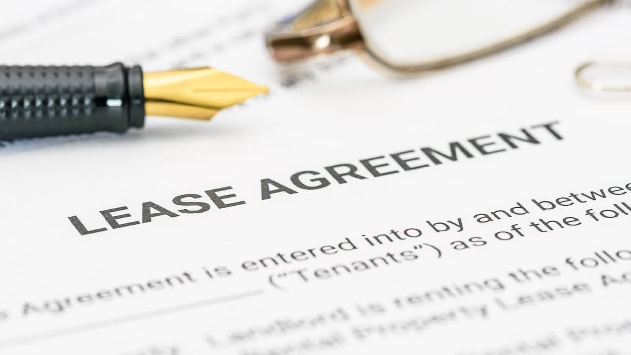 Pen and glasses on a lease agreement form.