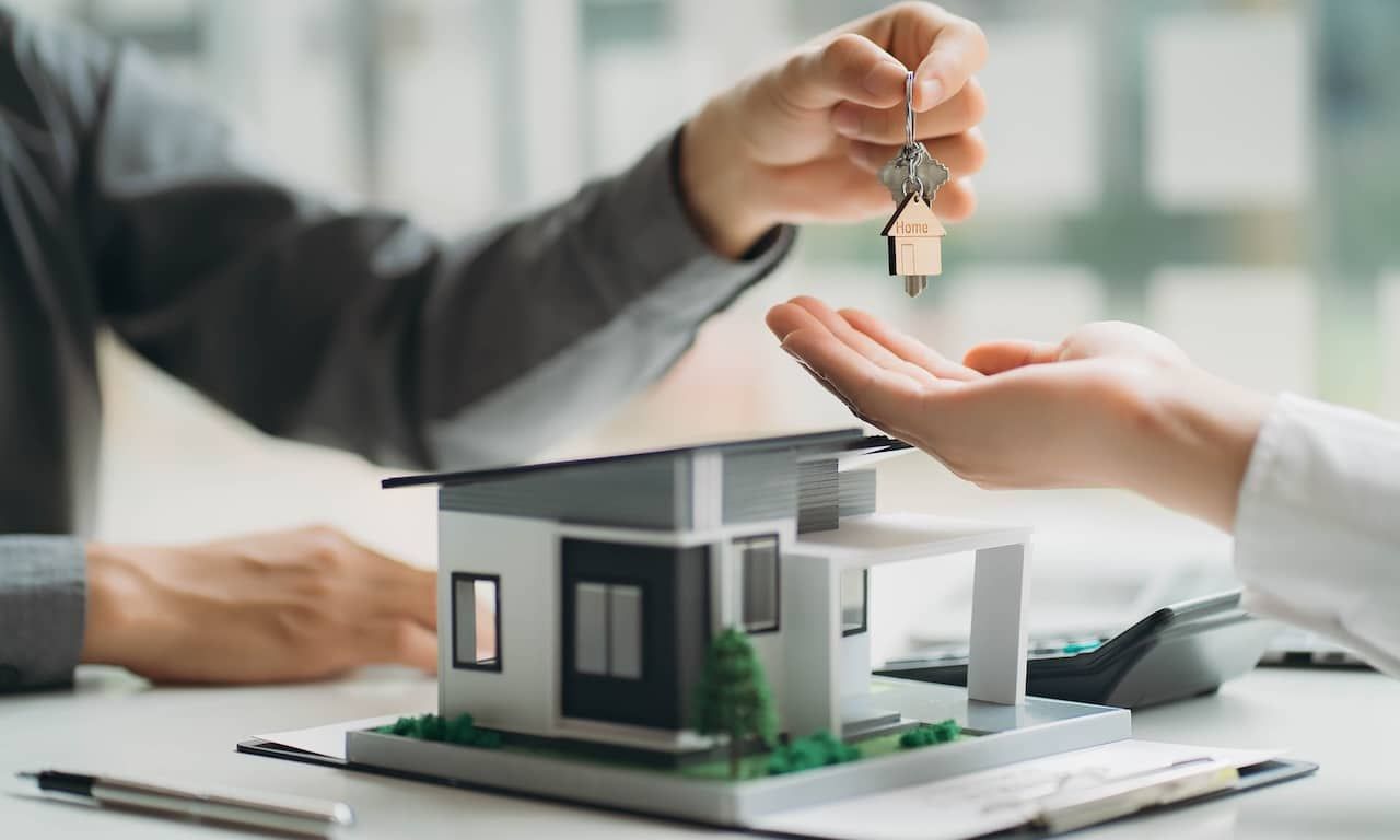 Real estate professionals and clients discussing home purchases