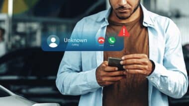 Receiving a scam call notification on a smartphone while standing outside