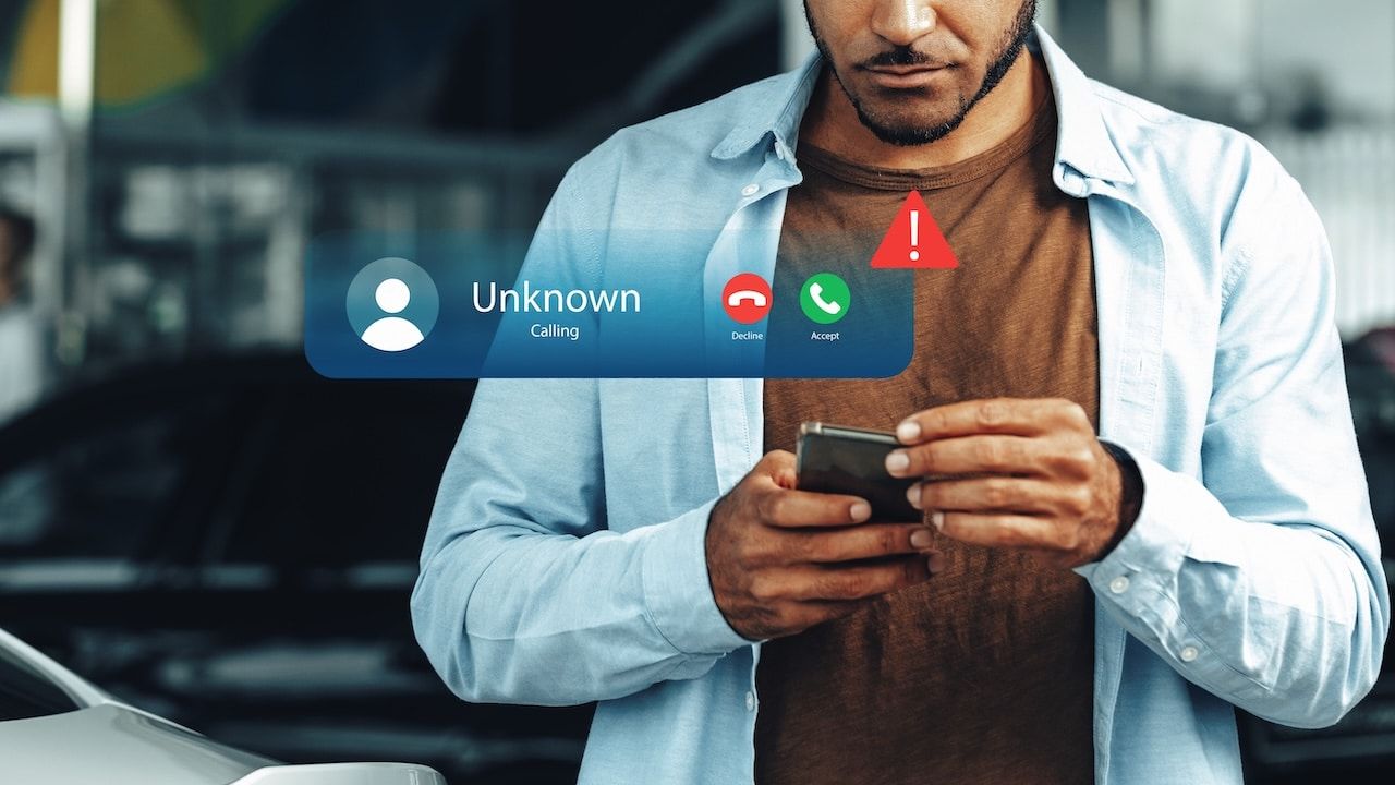 Receiving a scam call notification on a smartphone while standing outside