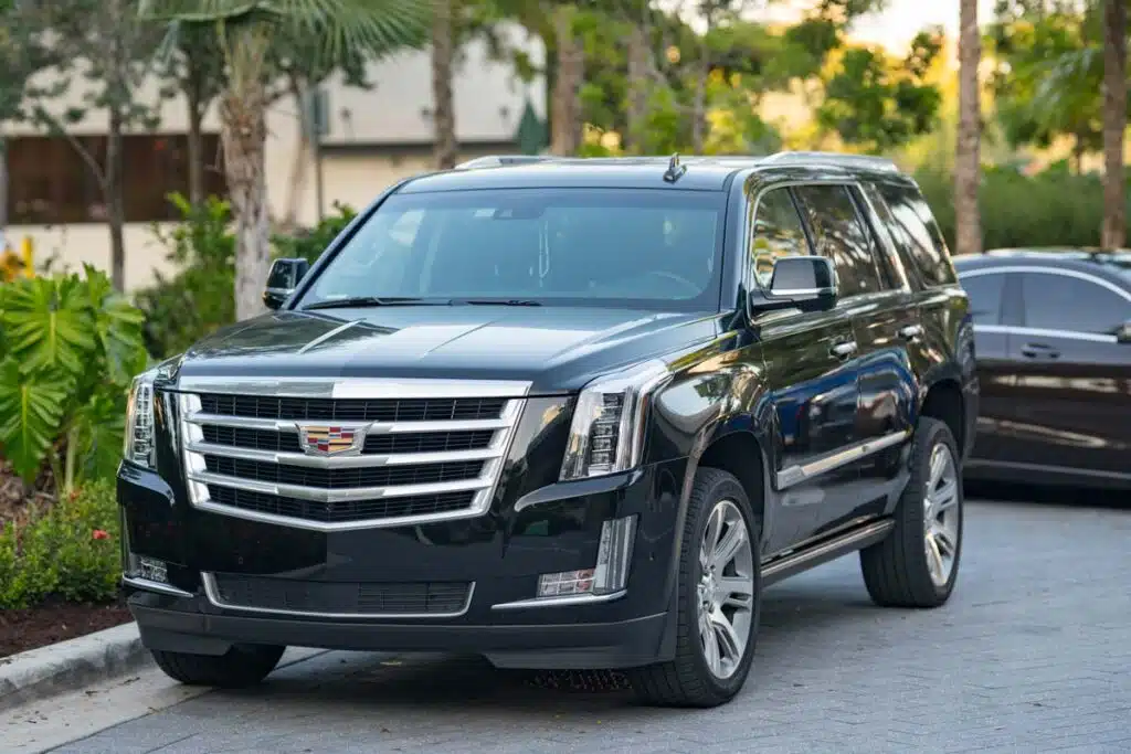A black Cadillac Escalade parked on a street, representing the GM class action.