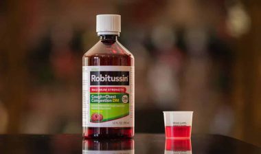 Robitussin bottle on a kitchen counter, representing Robitussin settlement.