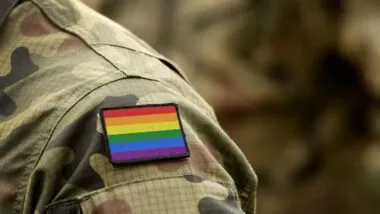 Close up of a rainbow flag patch on a military uniform, representing the LGBTQ vets class action.