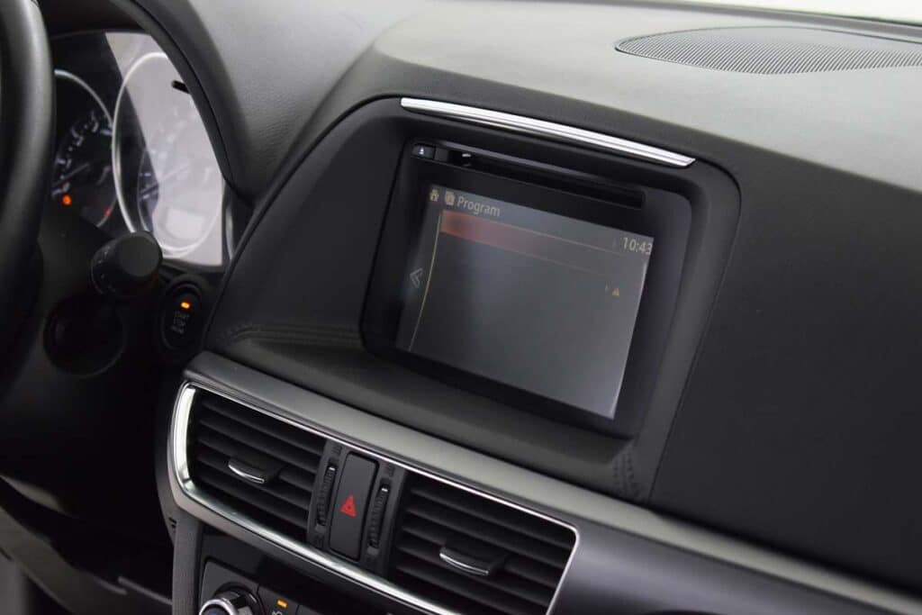 Close up of a 2016 Mazda CX-5 infotainment center, representing the Mazda class action.