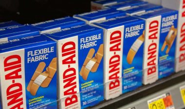 Close up of Johnson & Johnson Band-Aid products on a supermarket shelf, representing the Band-Aid class action.
