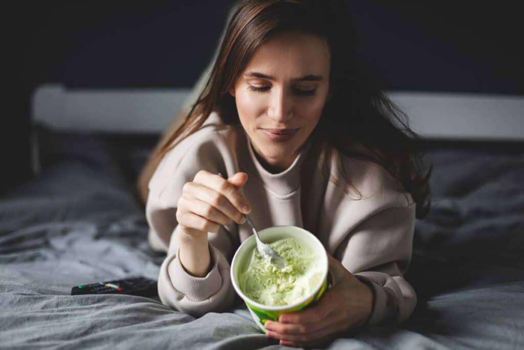 A woman eating a pint of ice cream, representing the Totally Cool class action.