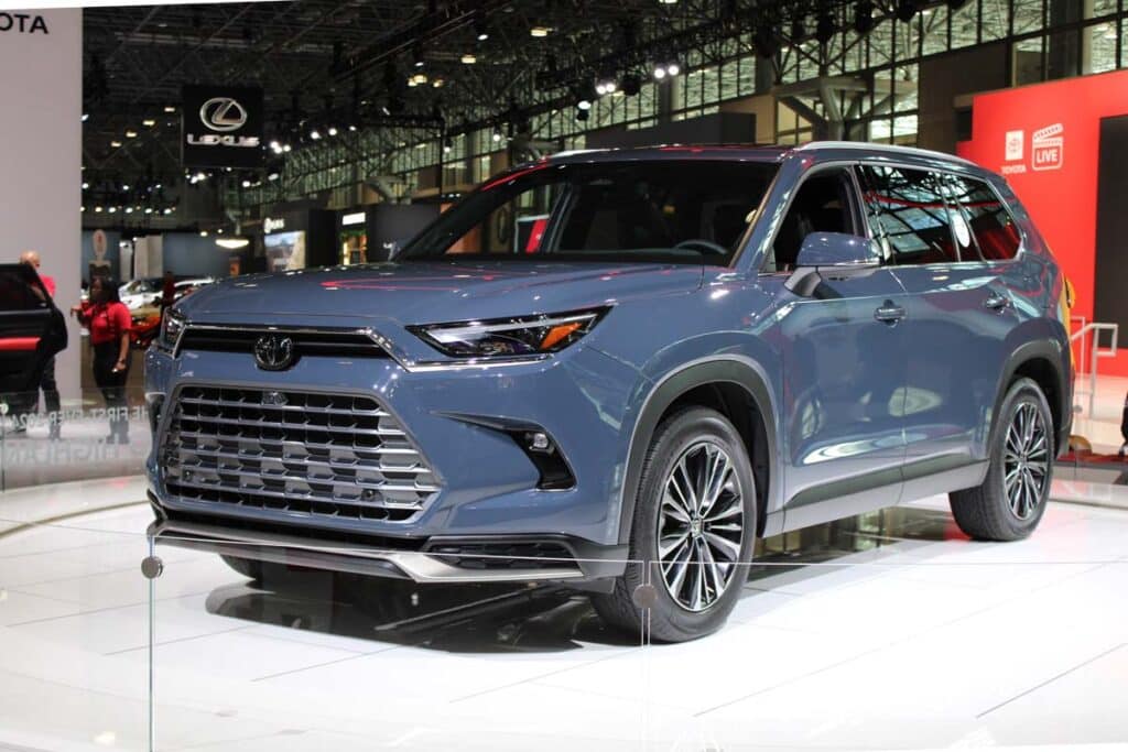 A blue 2024 Toyota Grand Highlander at a car show, representing the Toyota recall.