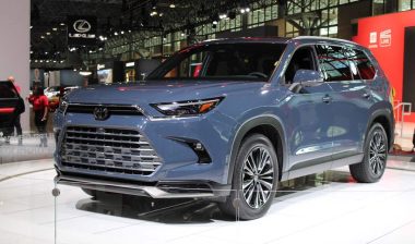 A blue 2024 Toyota Grand Highlander at a car show, representing the Toyota recall.