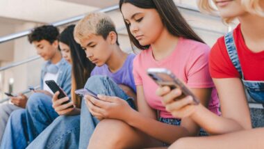 A group of minors using their smartphones, representing the Google class action.