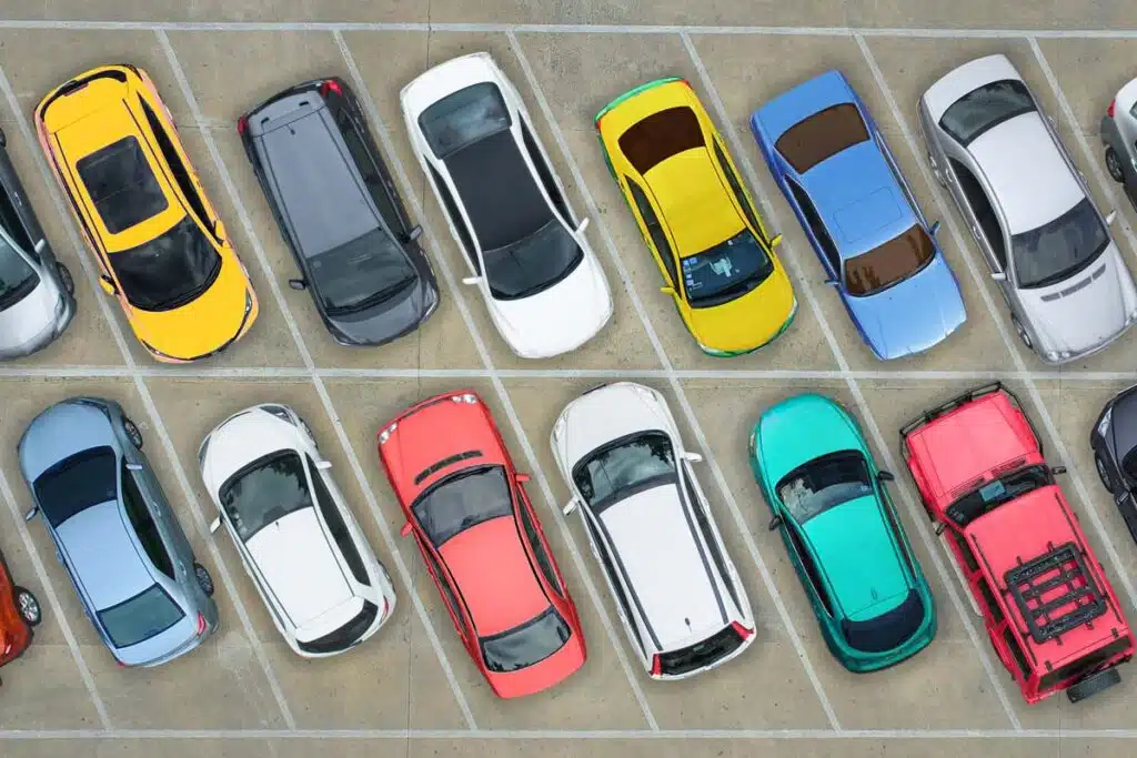 Aerial view of various cars in a lot, representing June auto recalls.