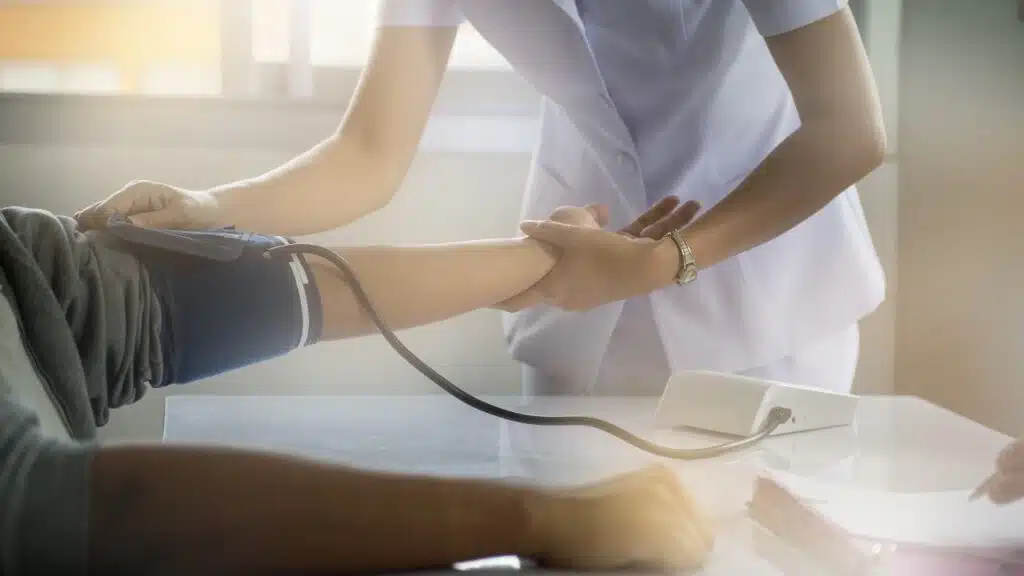 Nurse practitioner taking blood pressure