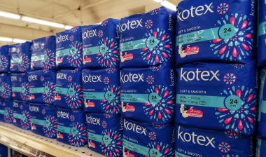 Kotex tampon products on a supermarket shelf, representing the Tampax and Kotex class actions.