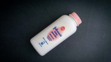 Johnson baby powder against a black backdrop, representing the Johnson & Johnson talc verdict.