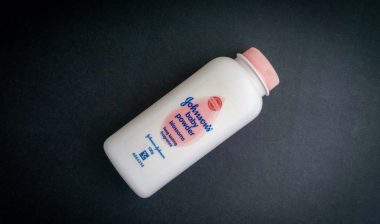 Johnson baby powder against a black backdrop, representing the Johnson & Johnson talc verdict.